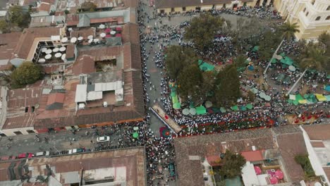 bird's eye view over the processions of lent and holy week in antigua guatemala - drone shot