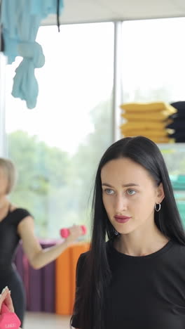 young women doing pilates in the gym with arms raised toning muscles with dumbbells young women doing pilates in the gym with arms raised toning muscles with dumbbells a healthy sports lifestyle