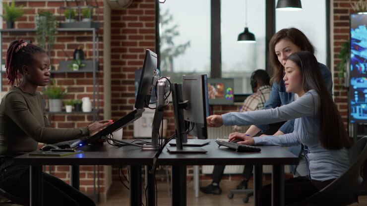 Professional office workers analyzing blueprint project on multi monitors