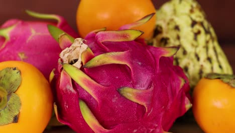 vibrant dragon fruit and persimmons displayed together