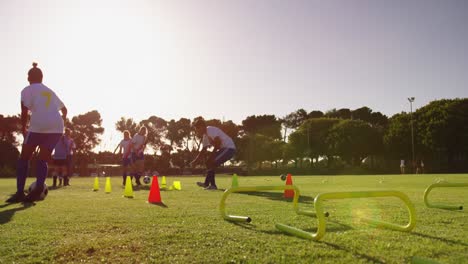 Female-soccer-team-training-with-slalom-on-soccer-field-4k