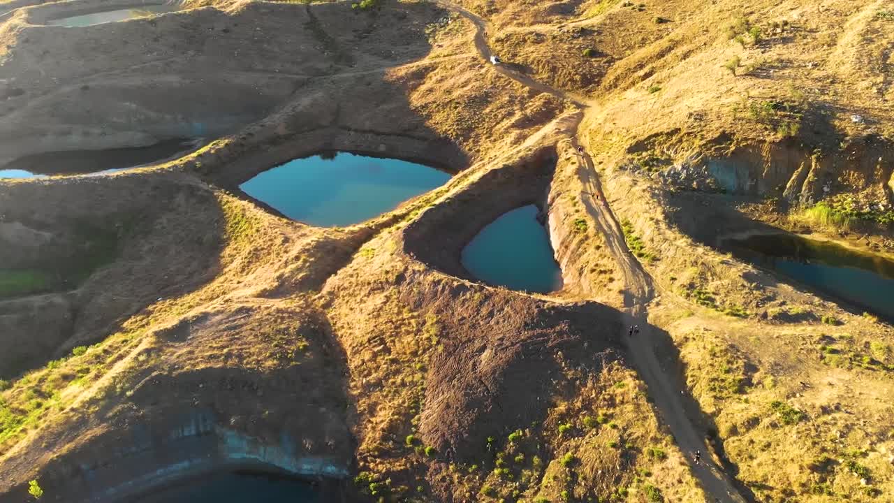 Explore Falougha’s majestic landscapes from the sky, featuring turquoise lakes and endless green pine forests