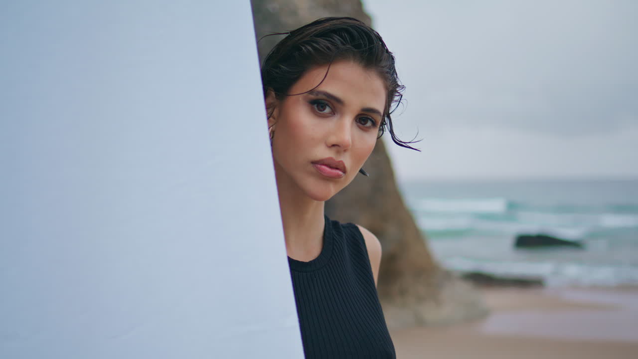 mujer de glamour posando en la orilla de primer plano. modelo de moda profesional mirando cámara