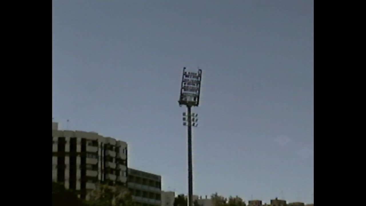 Children gathered on athletic field with coach