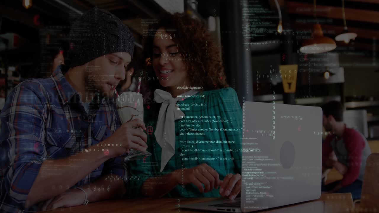 Couple glancing at laptop screen and alternating milkshake sips while collaborating on tech project