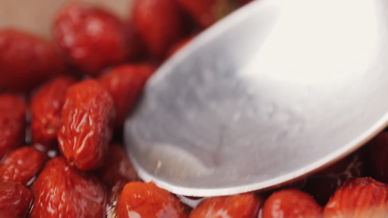 Preparing Dried Red Fruit with Spoon