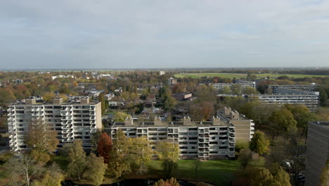 High-jib-up-over-high-rise-buildings,-revealing-a-beautiful-suburban-neighborhood-in-a-rural-town