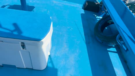 a boat gently sways on bright blue waters in phuket, thailand. the video captures the serene marine environment with vivid colors