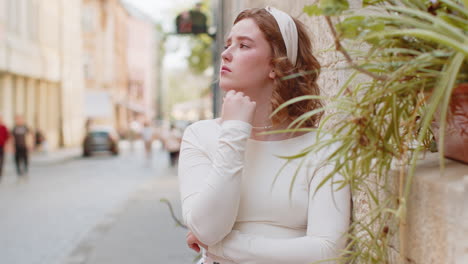 sad unhappy frustrated young woman walking alone in city street feeling bad annoyed grief problem