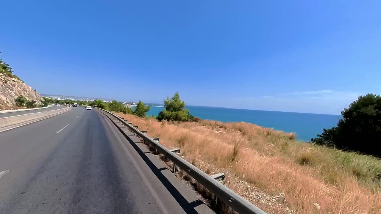 Beautiful open road stretching along Mauritius’ stunning coastline with blue seas and rugged shores