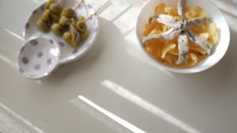 delicious spanish tapas with green olives and crispy chips topped with anchovies