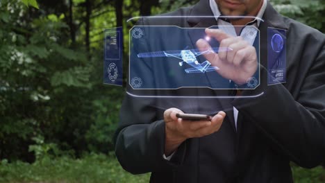 un hombre de negocios usa un holograma con un avión de hélice.