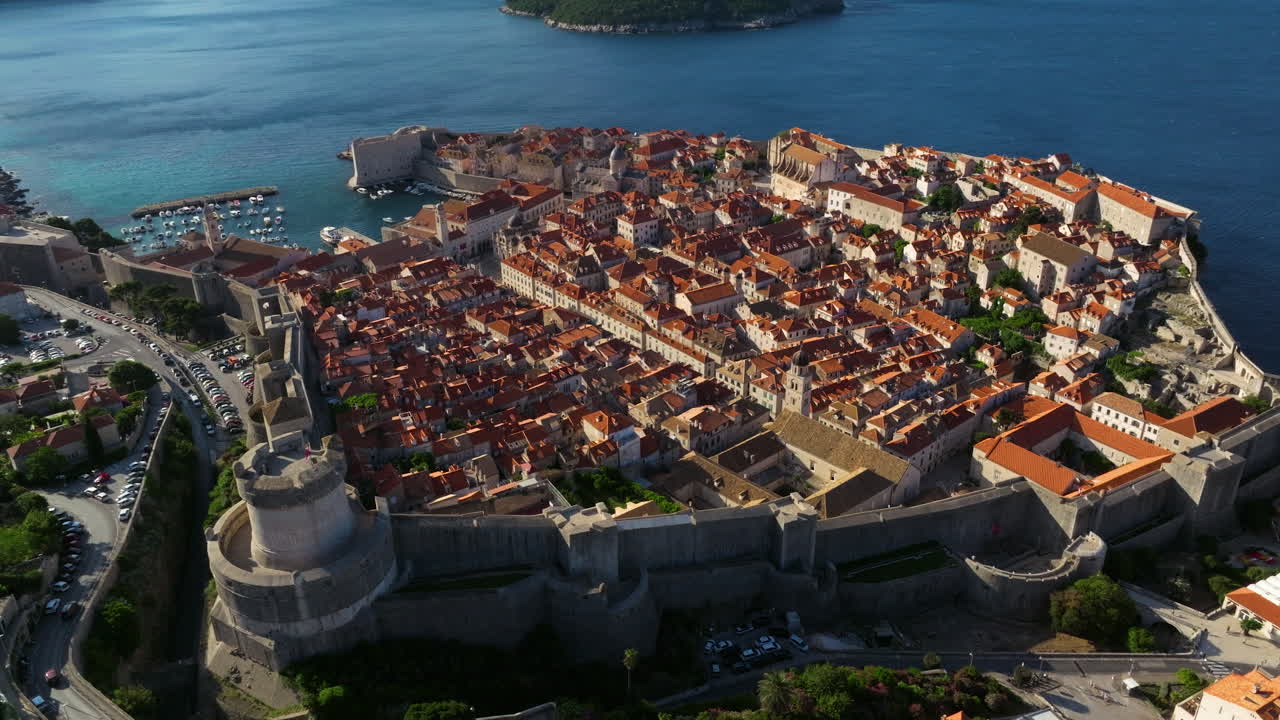 Early Morning Of Dubrovnik's Old Town In Croatia, With Medieval City Walls On Adriatic Sea Coastline. aerial orbiting shot