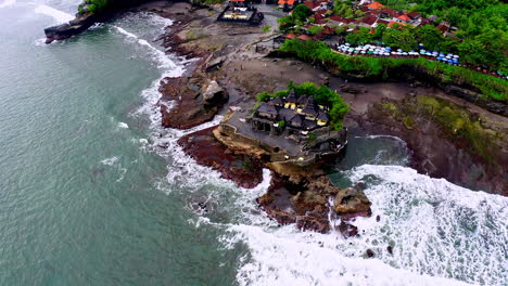 ancient hindu temple of tanah lot on rock formation in sea waves, bali