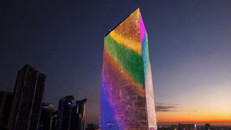 colorful illuminated skyscraper at dusk