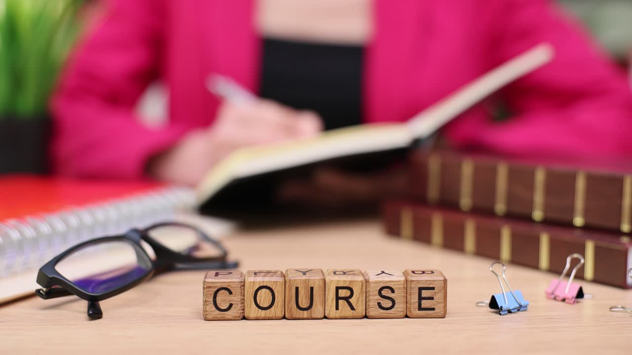 A woman studies a course with books and notes