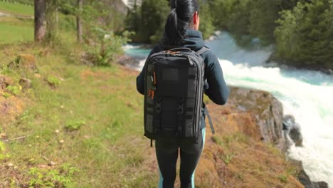 hiking woman walk with a hiking backpack in beautiful nature of norway.