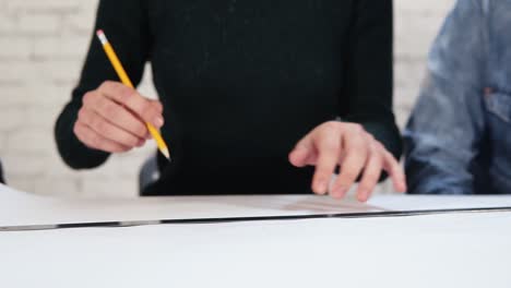 multi-ethnic-group-of-people-working-together-drawing-a-plan-using-pencil-and-ruler.-Happy-diverse-group-of-students-or-young