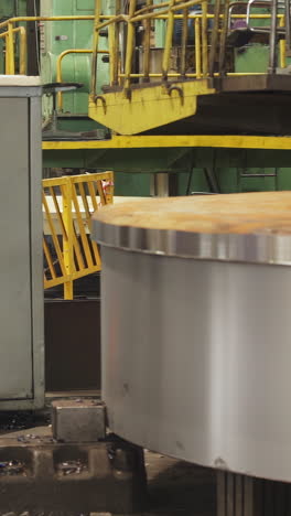 large industrial machine processing metal in a factory