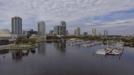 4k aerial drone video of sailboats at marina and beautiful skyline of downtown st