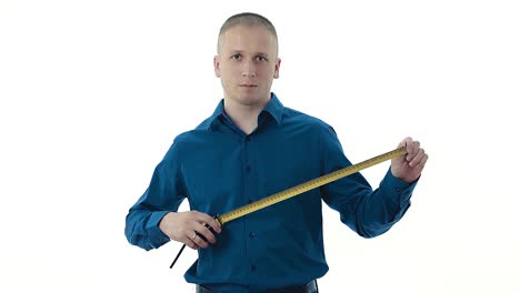 bald strong guy in dark blue shirt holds yellow measuring tape