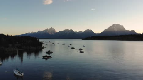 drone shot of a lake in wyoming with boats