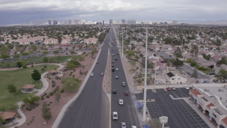 drone shot of traffic on a three lane motorway heading towards the city