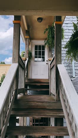 wooden porch stairs with white door