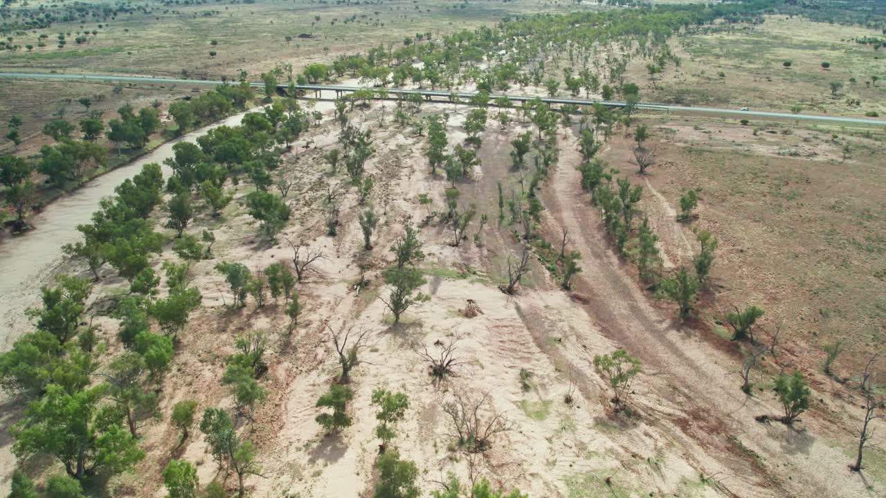 Drone view of the dry Hugh River as it passes under the Stuart Highway. Northern Territory, Australia. August 2022.