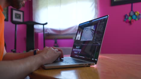 Man-Using-A-Laptop-Computer-At-Home---close-up