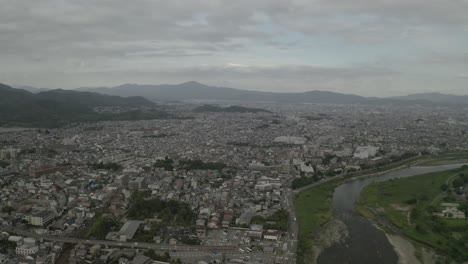 Toma-Aérea-De-Kyoto-Con-Drones-Al-Atardecer-Cerca-De-Un-Río,-Japón,-Asia