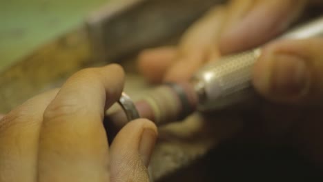 italian goldsmith at work building an engagement or a wedding ring