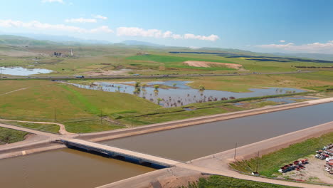 Spring-rains-in-2023-flooded-California's-aqueduct-and-canal-system-to-overflowing---aerial