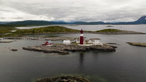 tranoy lighthouse with sea and mountains in the background in nordland county, norway