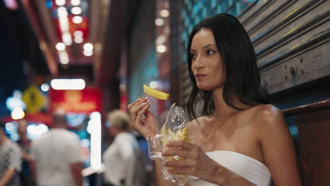 woman enjoying street food at night market