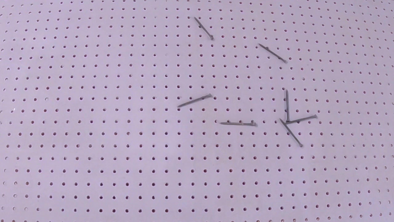 Black Screws Falling on Pegboard