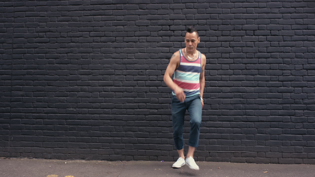 Contemporary funky Brazilian man street dancer dancing freestyle in the city