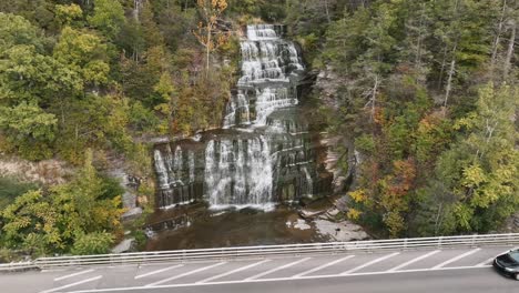 hector fall viewing point - cars driving through route 414 passing by hector falls and creek