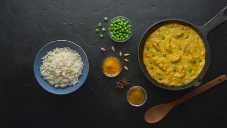 cinemagraph loop. cooking tasty chicken curry in pan with spices. flat lay, top view with copy space