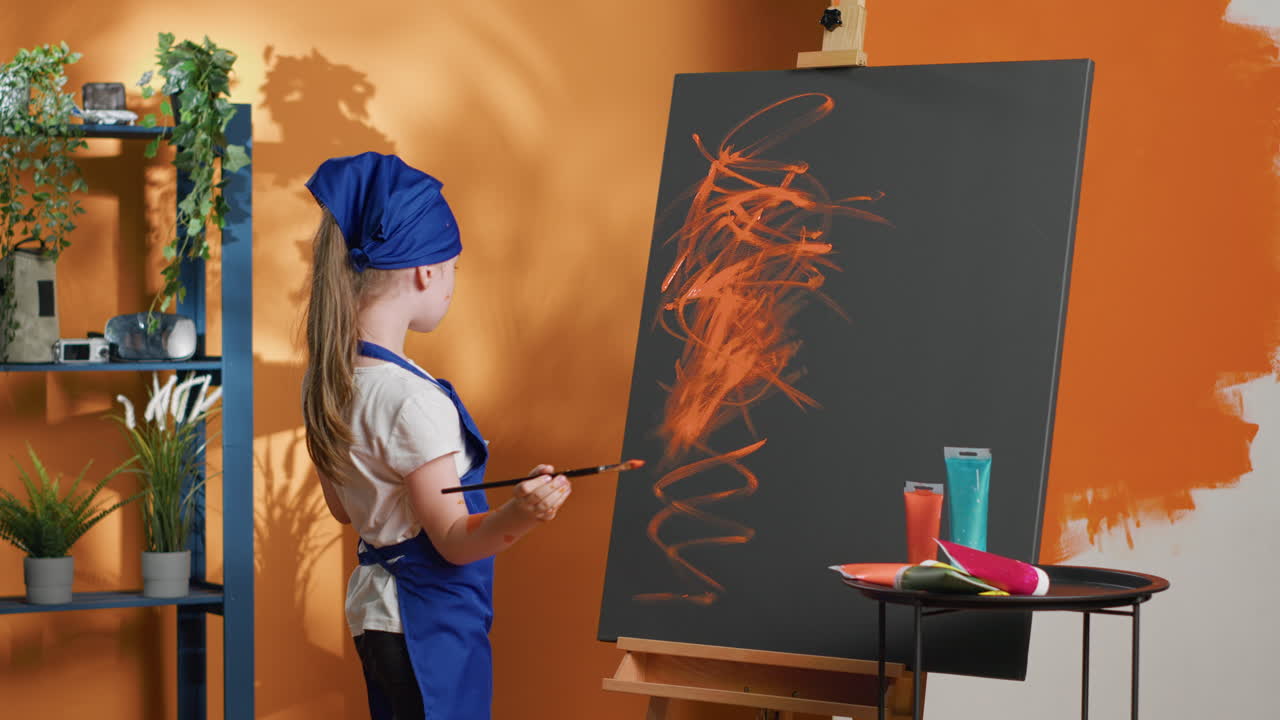 A child painting on a canvas in a studio