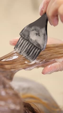 a closeup view of a professional hair dryer being skillfully utilized on long, beautifully flowing hair