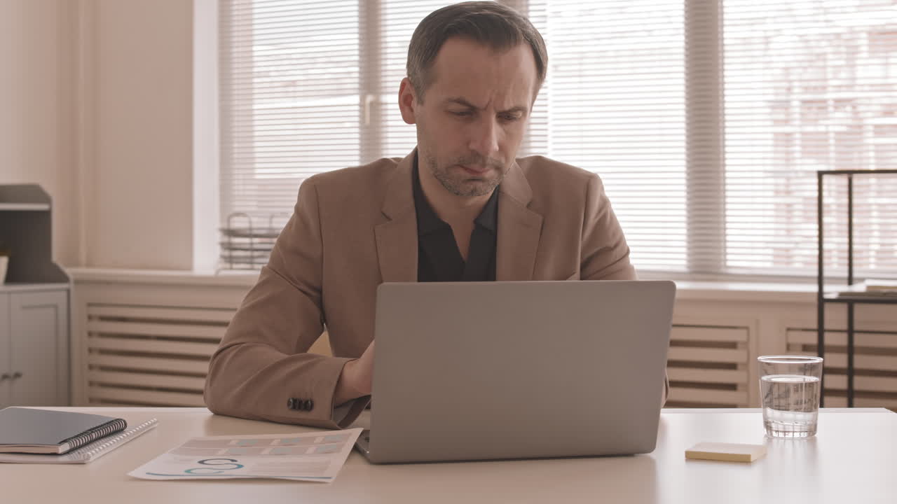 Caucasian Manager Using Smartphone in Office