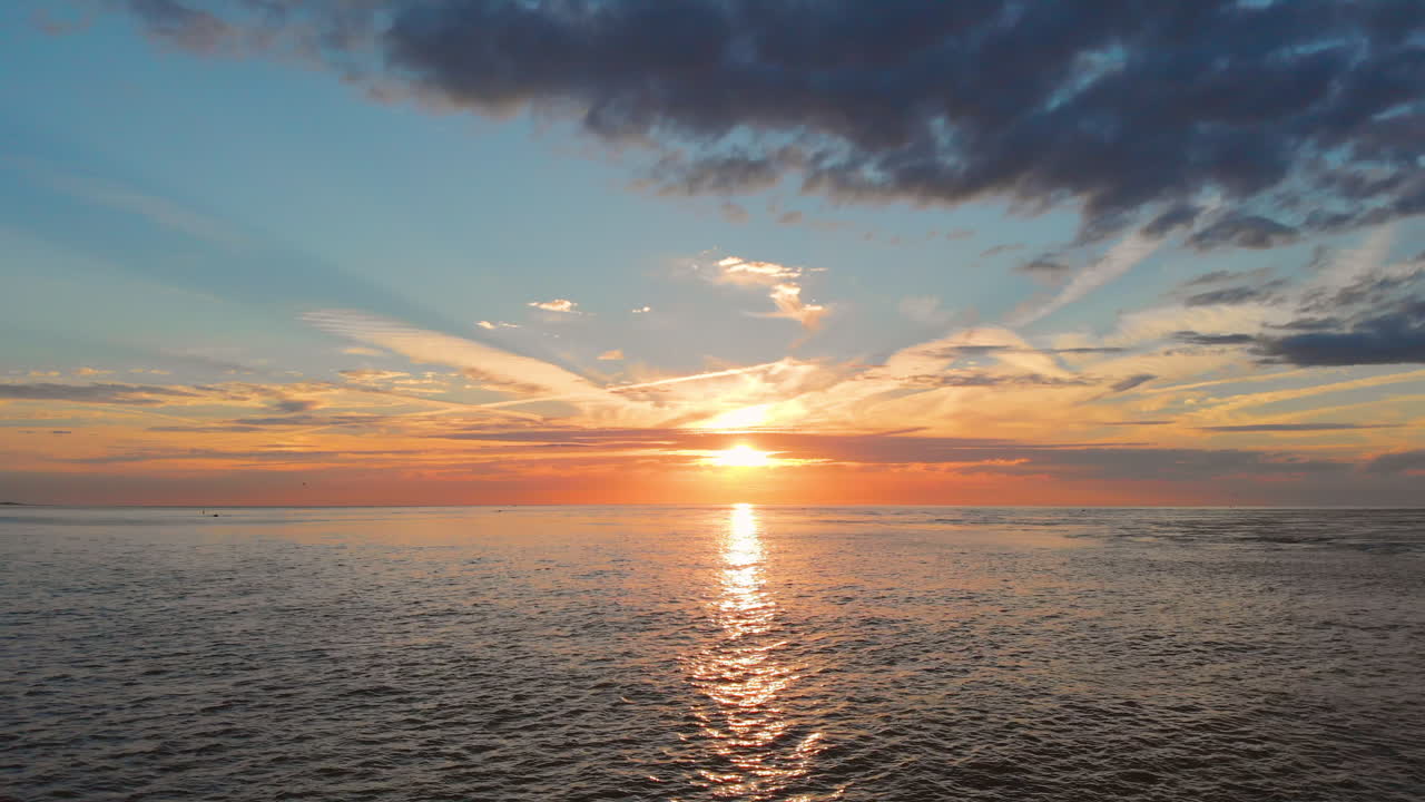 Premium stock video - A calm low tide at the beach near the stormsurge ...