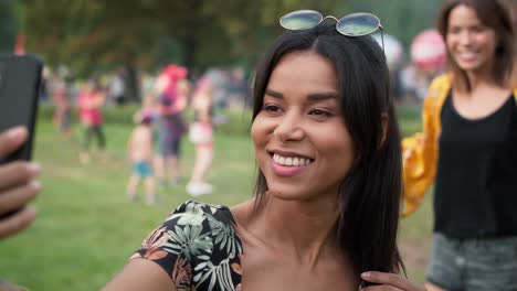 woman meet friends and making selfie at music festival.