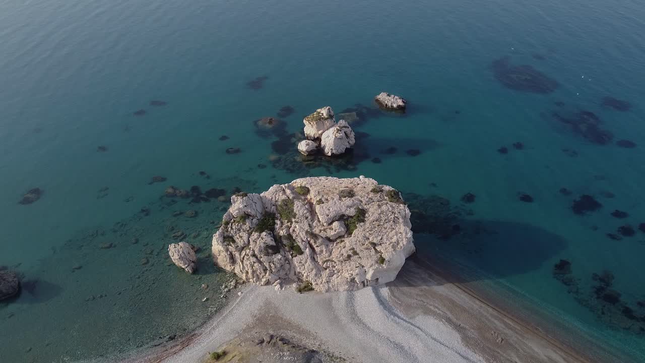 Aerial view of an unusually empty beach surrounding the popular landmark of Aphrodite's Rock. During the COVID-19 pandemic.