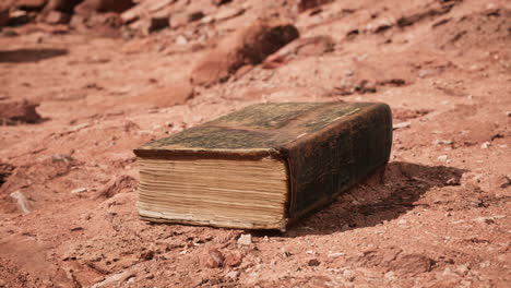 old book in red rock desert