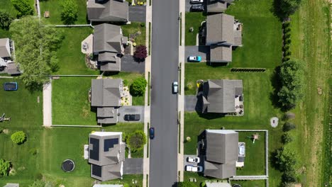 Aerial-top-down-shot-of-grey-rooftops-of-houses-in-idyllic-neighborhood-in-America