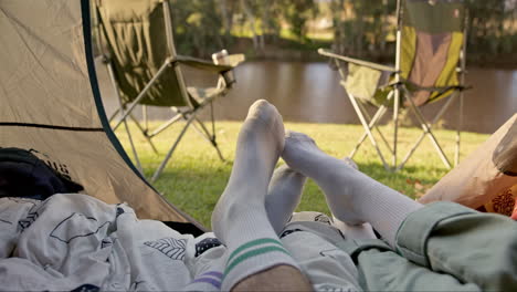 Camping,-tent-and-feet-of-couple-with-love