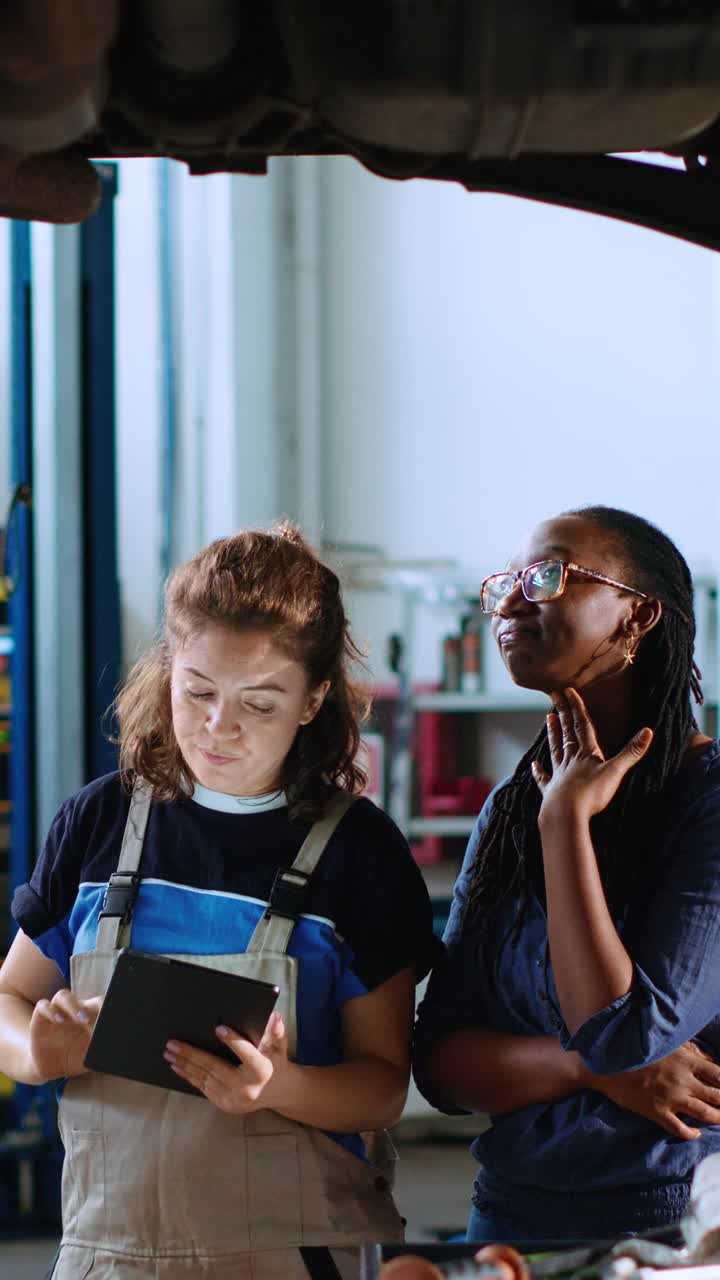 Vertical video Technician and woman look for car parts
