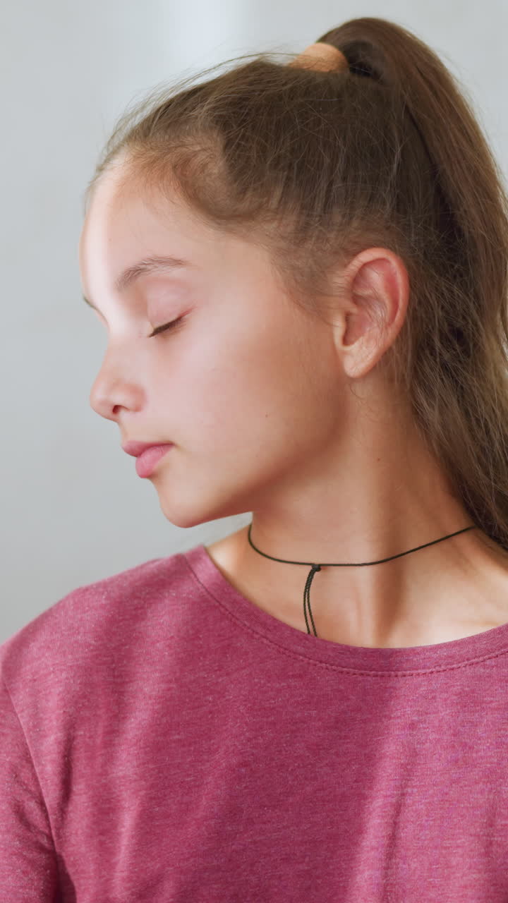 Caring sister hands over thermometer to sick brother to check his temperature, he is resting on the couch under a warm blanket, demonstrating sibling love and concern